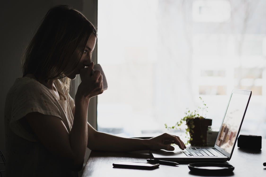 woman drinking and working